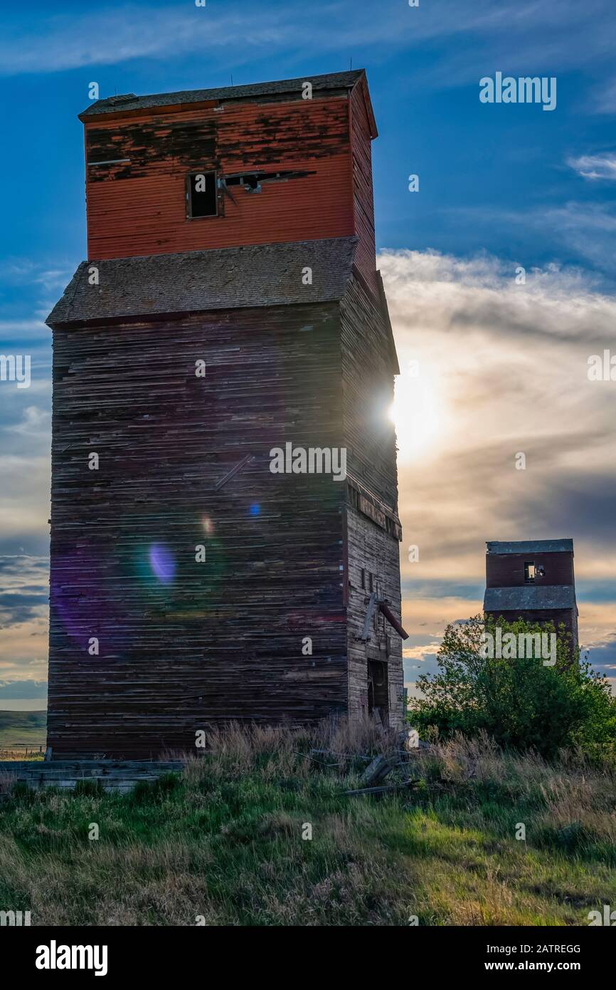 Abandoned and weathered grain elevator at sunset on the Canadian Prairies; Swift Current, Saskatchewan, Canada Stock Photo