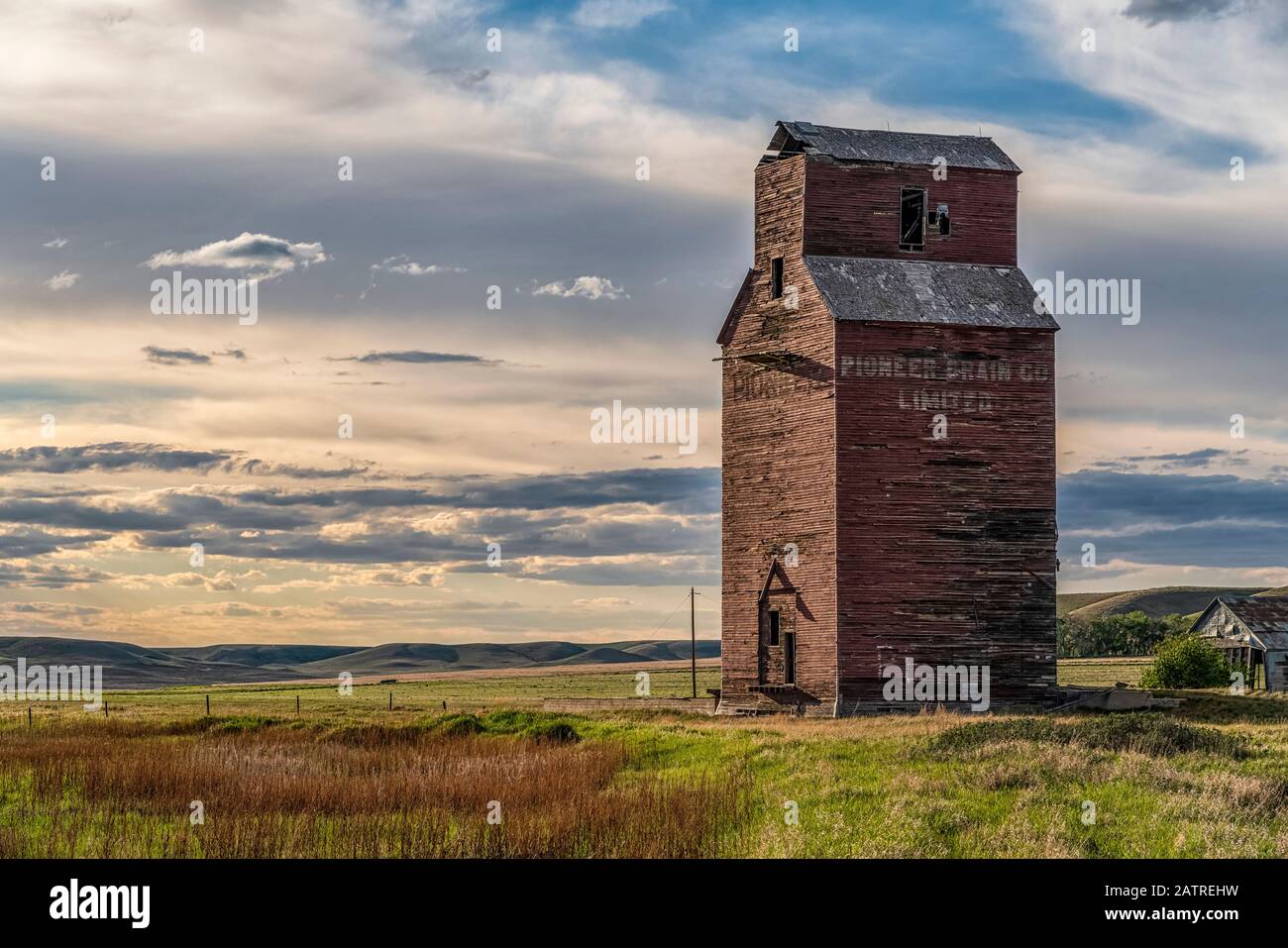Abandoned and weathered grain elevator at sunset on the Canadian Prairies; Swift Current, Saskatchewan, Canada Stock Photo