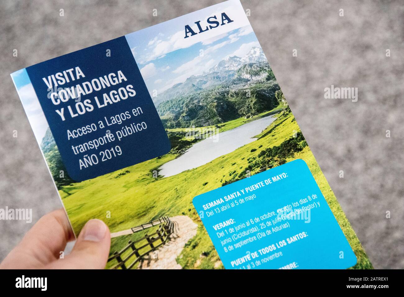 Cangas de Onis, Spain. Brochure with the schedules time tables of the ALSA buses transporting tourists to the Lakes of Covadonga Stock Photo
