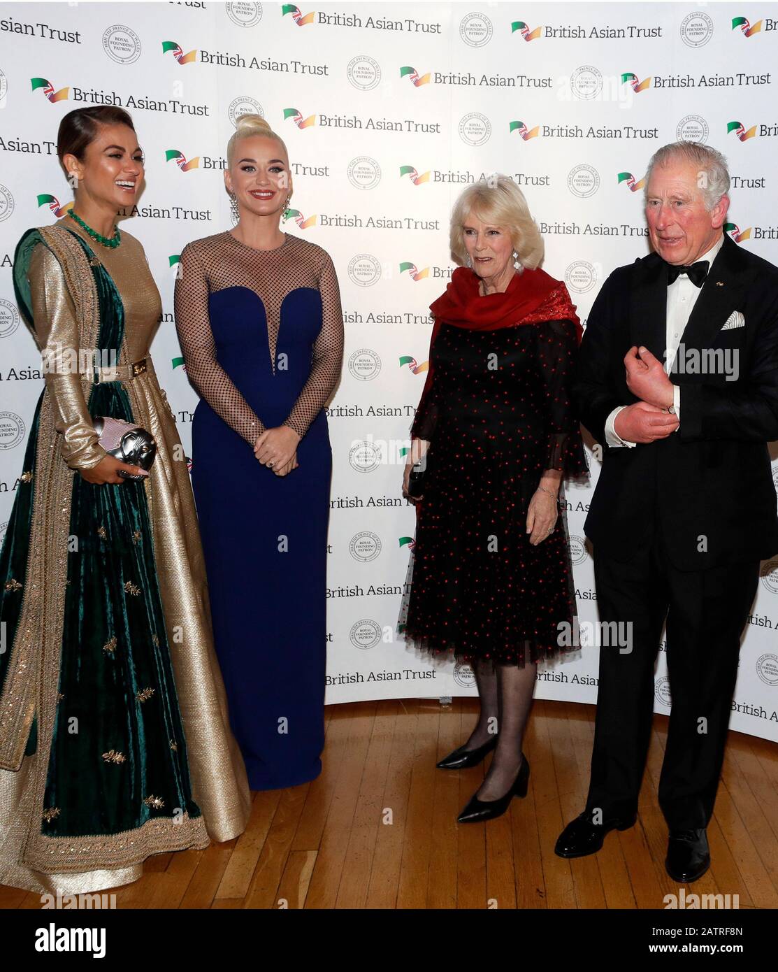 The Prince of Wales and the Duchess of Cornwall with Indian businesswoman Natasha Poonawalla (left) and musician Katy Perry (centre left), as they attend a reception for supporters of the British Asian Trust at Banqueting House, Whitehall, London. Stock Photo