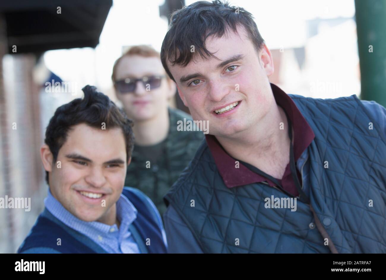 Middle Eastern man with Down Syndrome and two friends, each having a Learning Disability Stock Photo