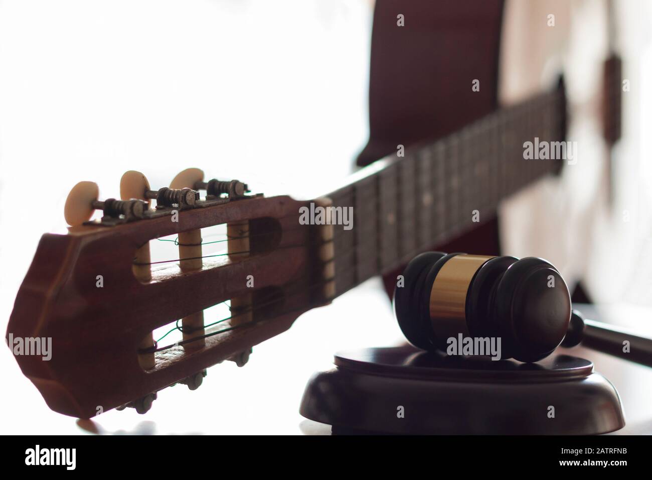 Judge's gavel and guitar. Concept of entertainment lawsuit, music
