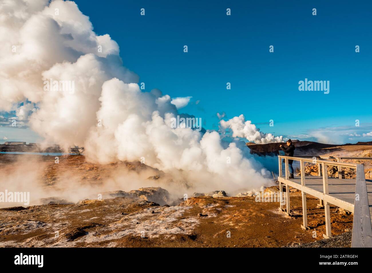 Tourist photographing the Gunnuhver Hot Springs, Reykjanes Peninsula; Iceland Stock Photo