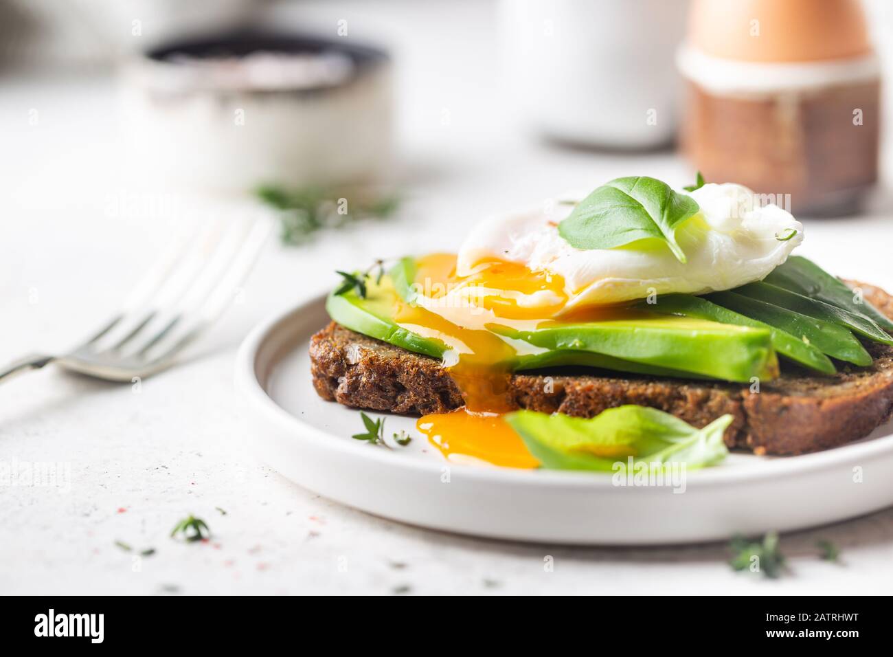 Healthy breakfast whole wheat toasted bread with avocado and poached