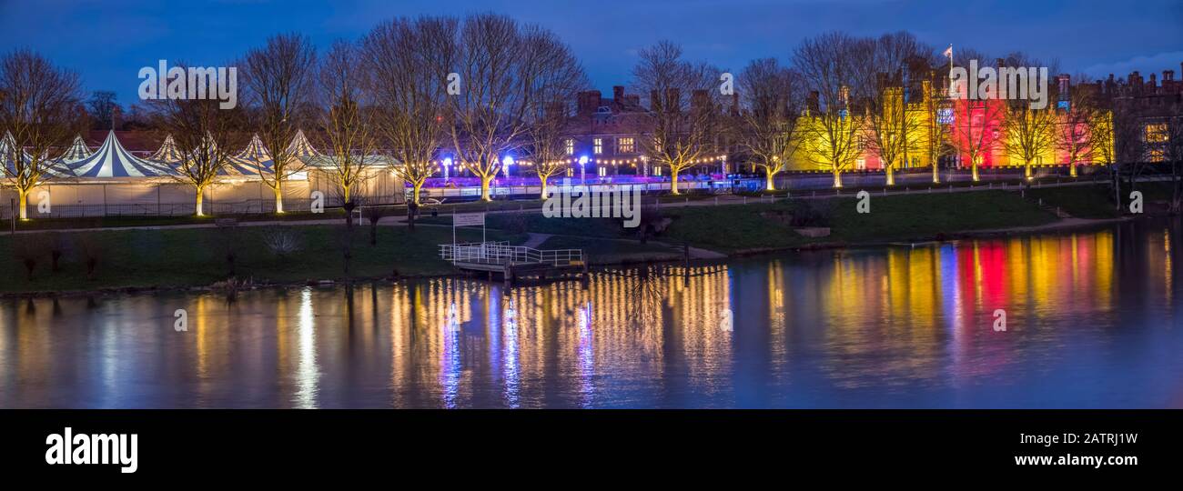 Hampton Court with Christmas lights glowing and reflected in the water