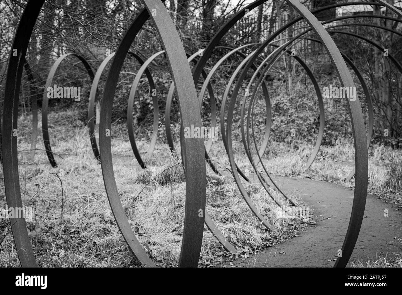 ‘Rotate’ by Trudi Entwistle – 40 giant steel hoops set in a circle on The Spen Valley Greenway which is a 7-mile route on the National Cycle Network Stock Photo