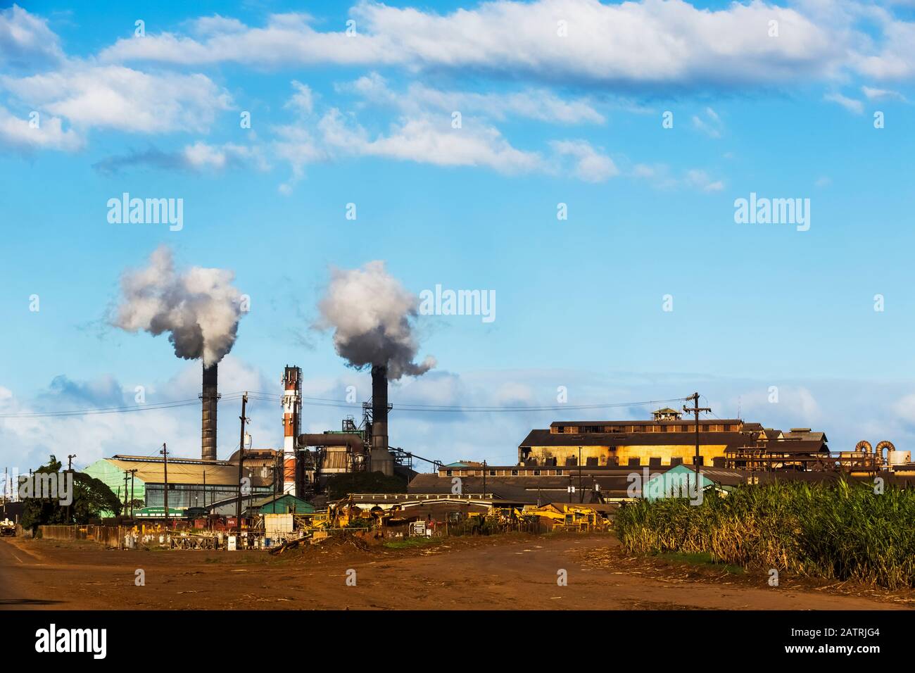 Smoke billowing from two stacks at a sugarcane processing plant near Kihei before the industry left the island in 2017 Stock Photo