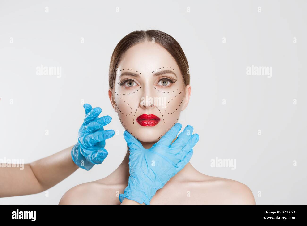 Facial cosmetic plastic surgery. Doctor surgeon hand in glove draw