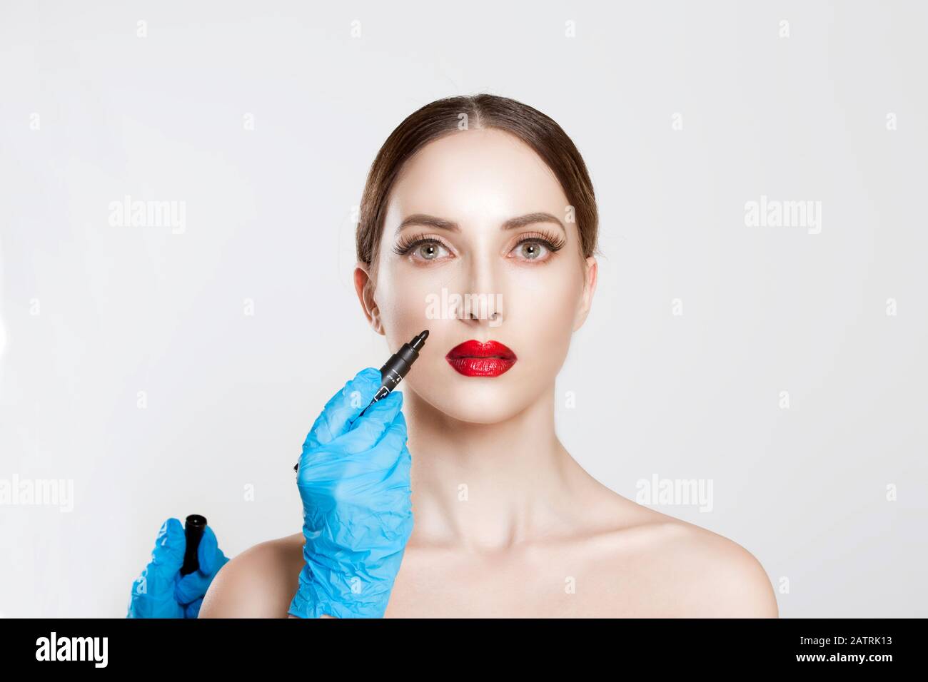 Anti wrinkle procedure. Nasolabial wrinkles reduction removal plastic surgery cosmetic filling operation concept. Doctor surgeon hand in gloves draw w Stock Photo