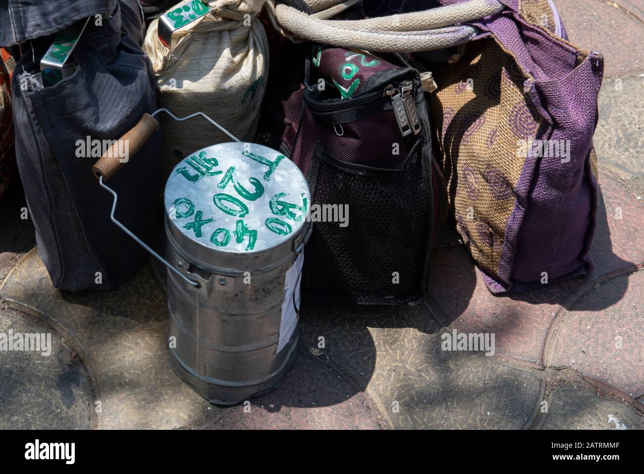 India, Mumbai aka Bombay. Dabbawalas (aka dabbawallas or dabbawallahs, tiffin wallahs) deliver lunches all over the city every day. Detail of lunches. Stock Photo