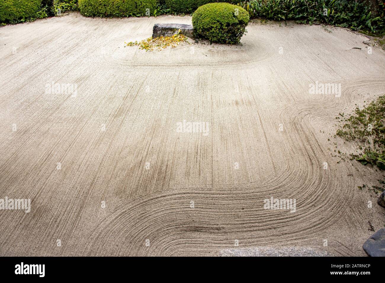 Zen garden with raked sand, rock and bush, Shishen-do Temple,Kyoto, Japan Stock Photo
