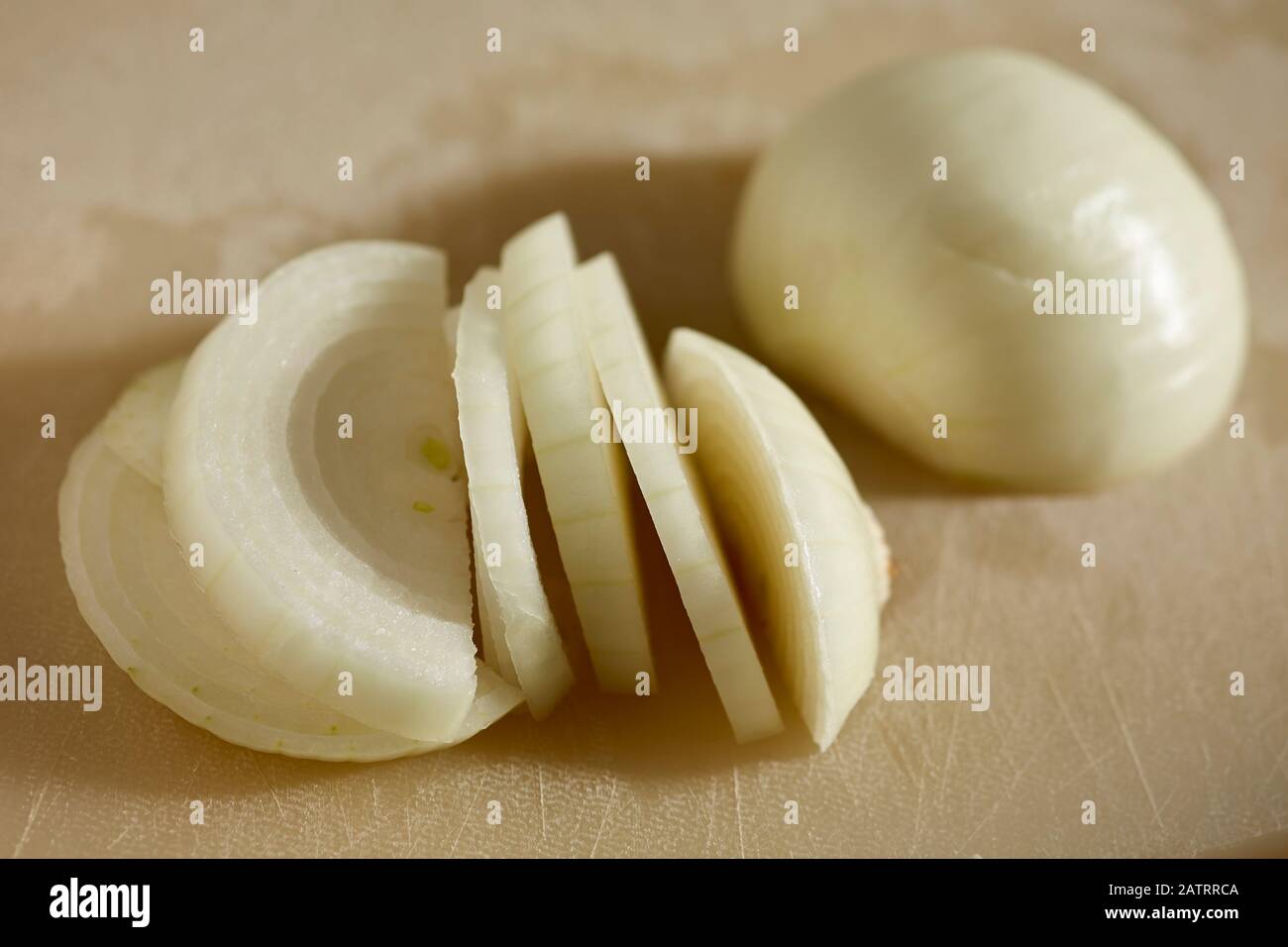 A peeled and sliced yellow onion Stock Photo