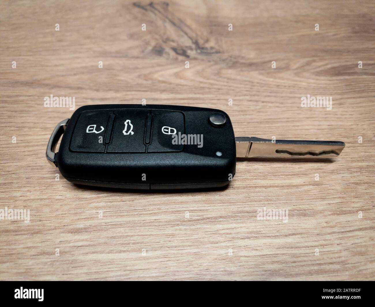 New remote car key fob on the wooden background locksmith service.- Image Stock Photo