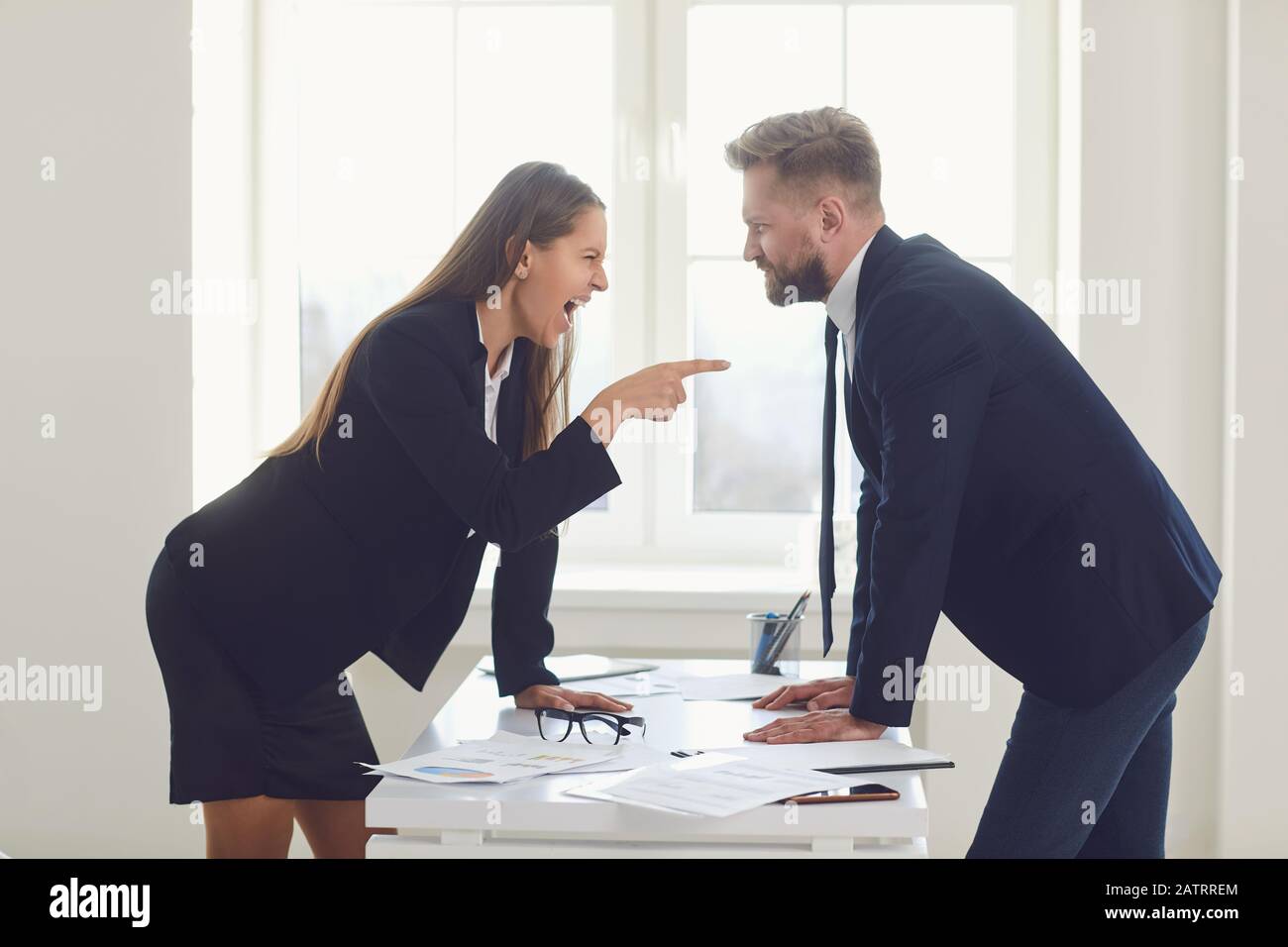 Business conflict. Competition conflict dispute business angry people at a table in an office Stock Photo