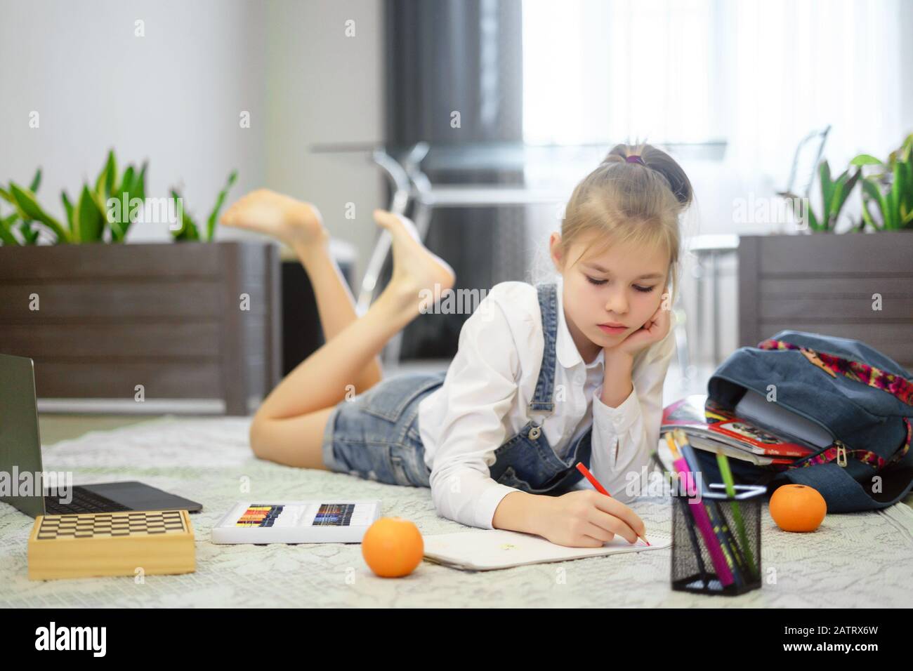 Cute little girl is drawing on a floor Stock Photo - Alamy