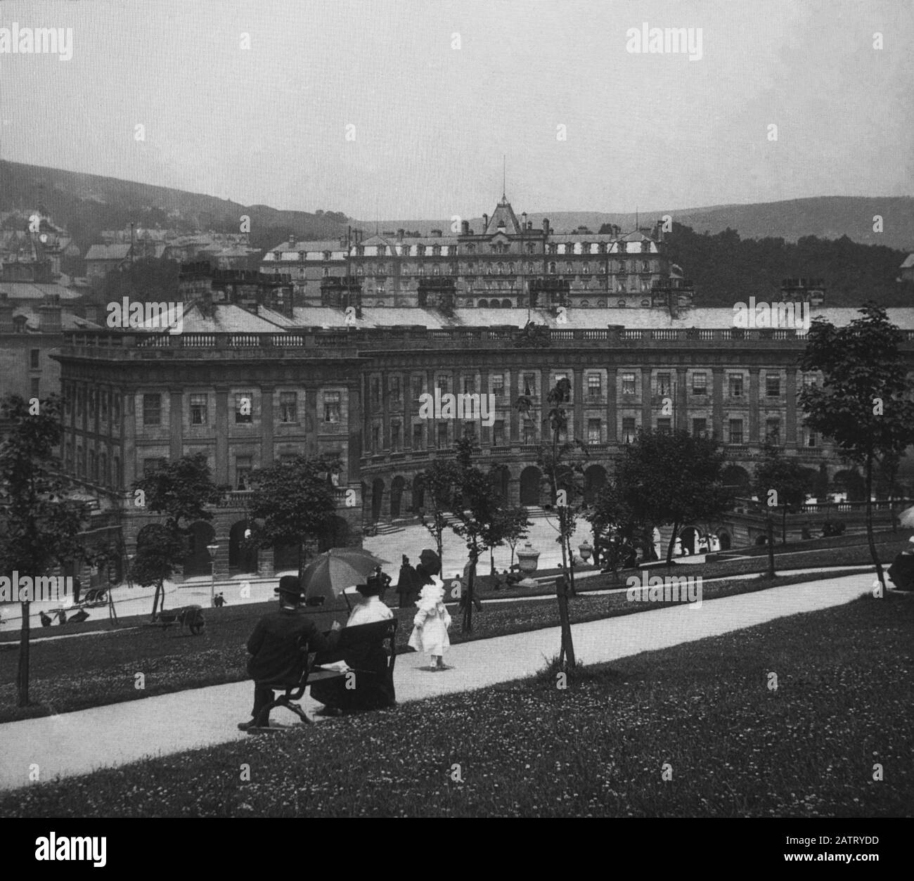 Buxton Crescent & Thermal Spa Hotel & Palace Hotel during the Victorian period c1890, Victorians in front of the Bath House, antique old glass magic lantern slide picture. The newly renovated hotel is due to open in 2020 creating a northern capital for health and wellbeing. Antique Magic Lantern Slide.  Original photographer unknown, copyright period expired.  Digital photography, restoration, editing copyright © Doug Blane. Stock Photo