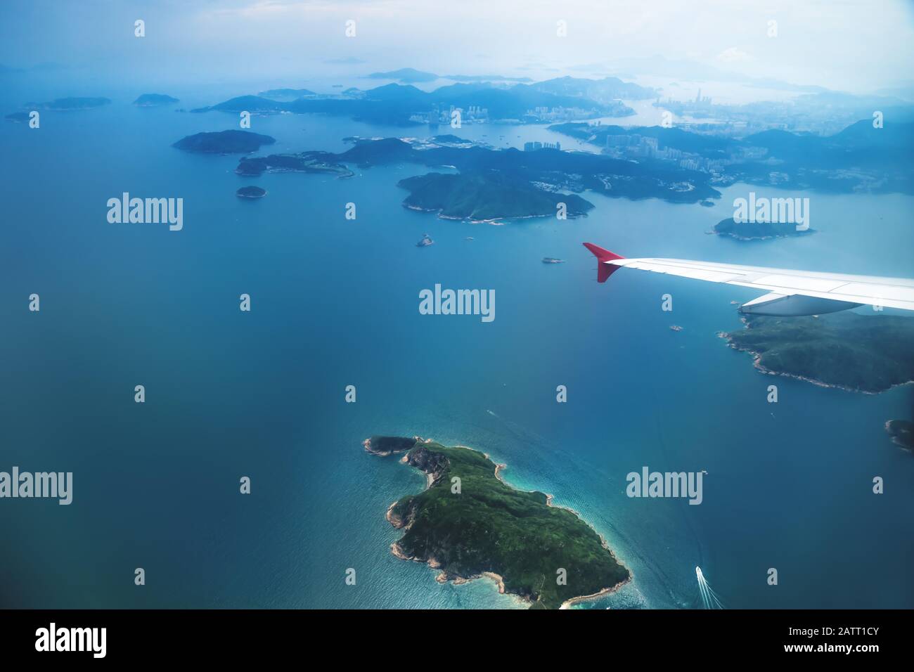 Aerial view of Hong Kong islands from a flying airplane with wing, China Stock Photo