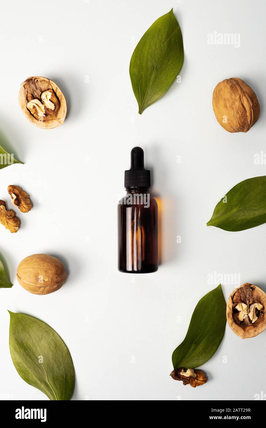 Walnut cosmetic moisturizing serum on a pastel blue background