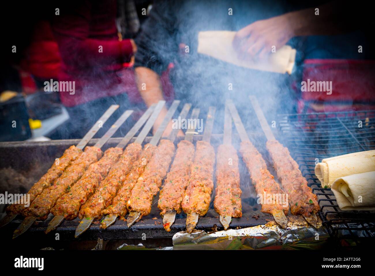 Kebab or kebap on metal skewer barbecue and embers in the kebab