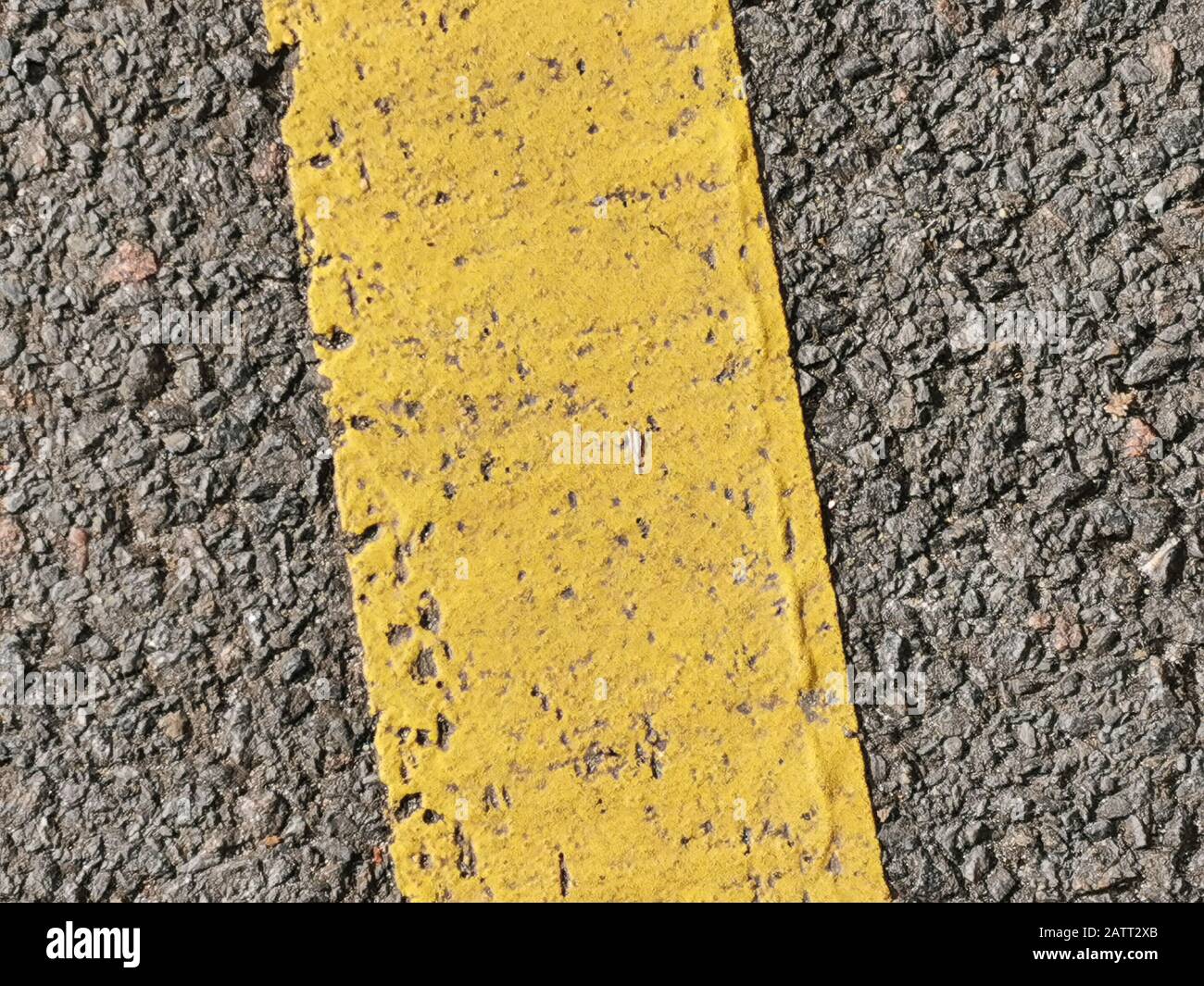 Texture of macadam asphalt with yellow line painted for design