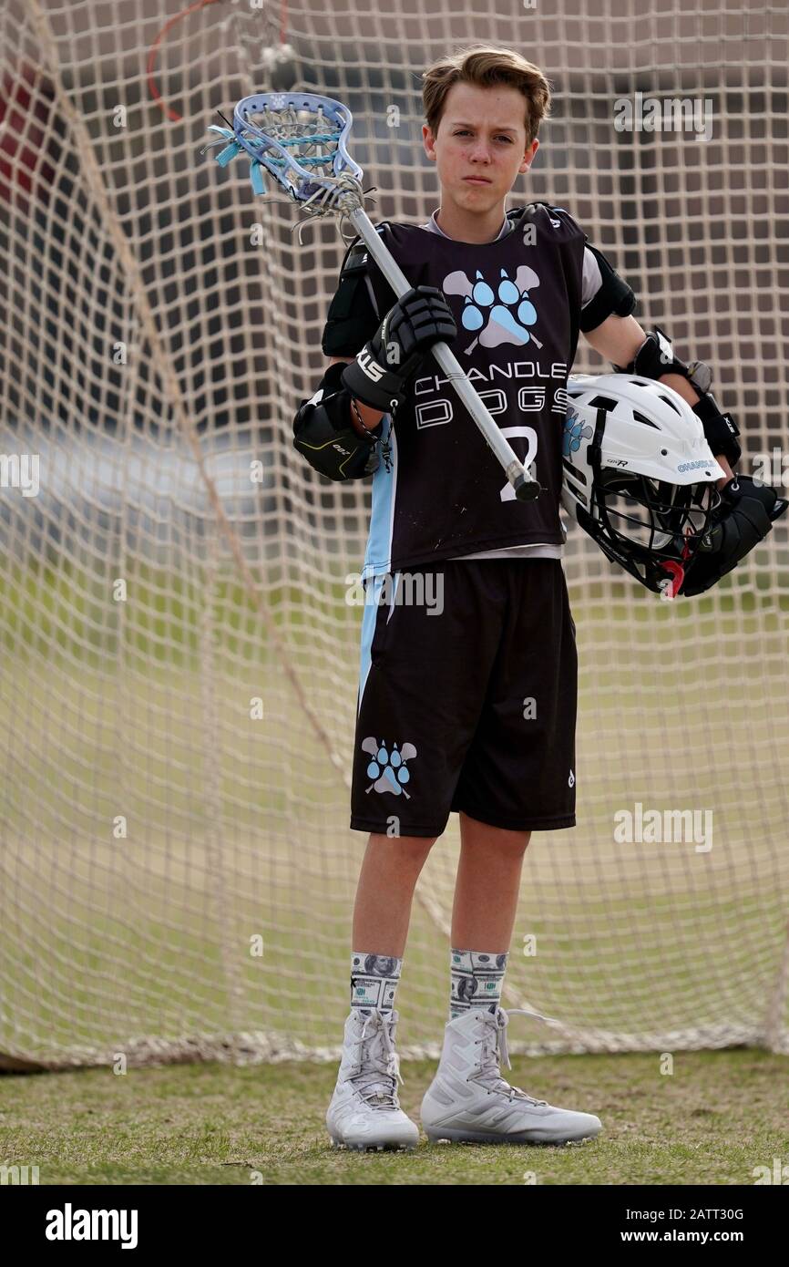 A teenage boy lacrosse player poses for a portrait. Stock Photo