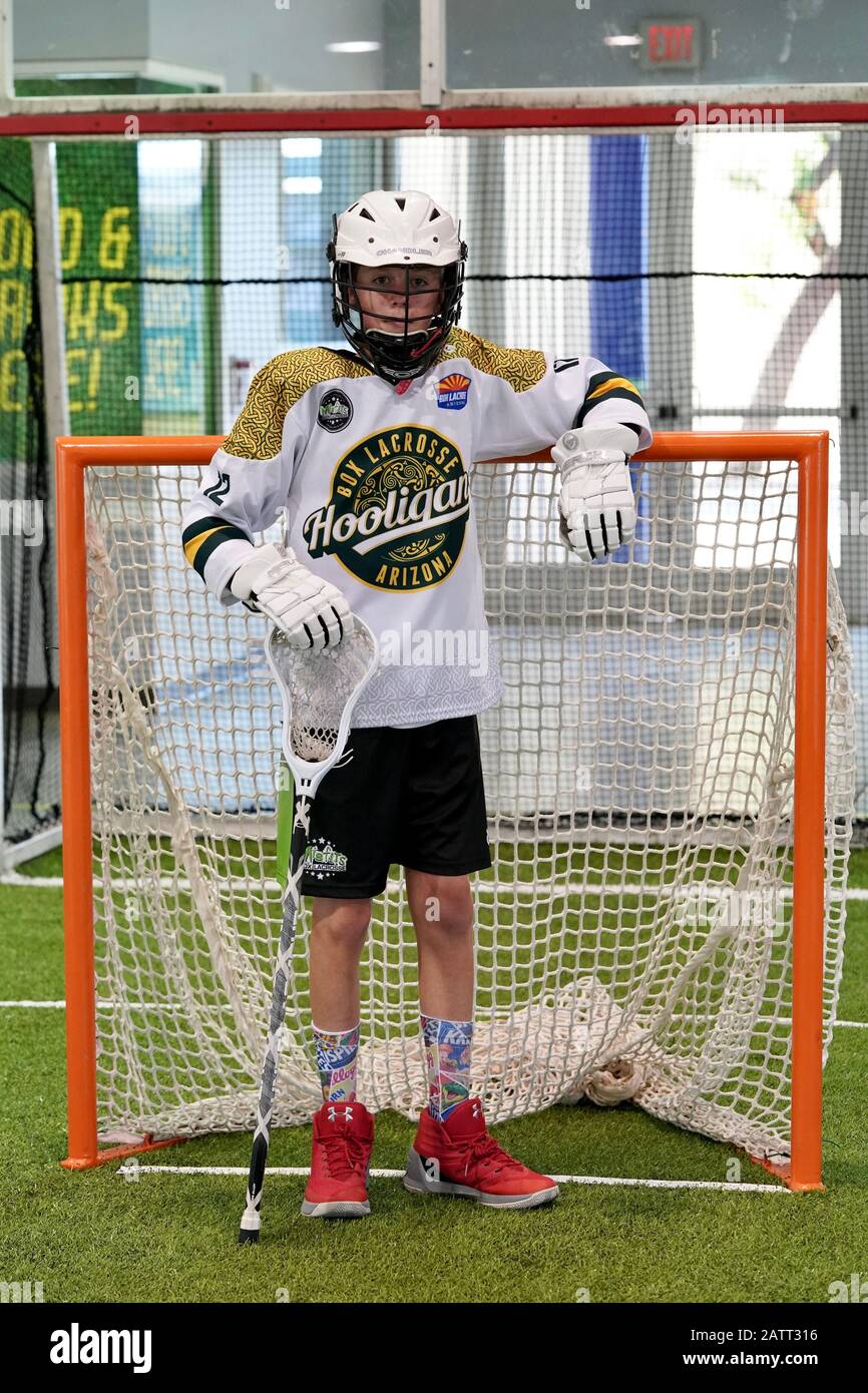 A teenage boy indoor lacrosse player poses for a portrait. Stock Photo