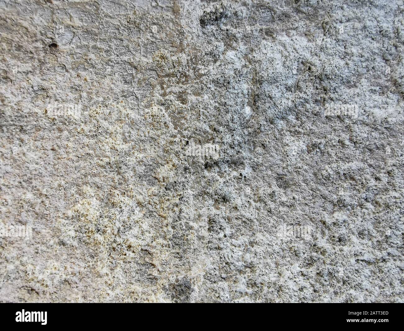 Texture of very old grey stone wall with colored stains for design ...