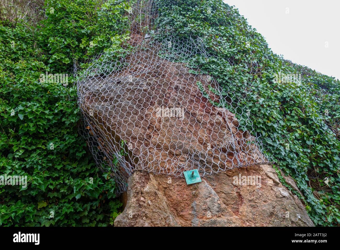 Metal Mesh covering loose rock to stop it falling off, England, UK Stock Photo
