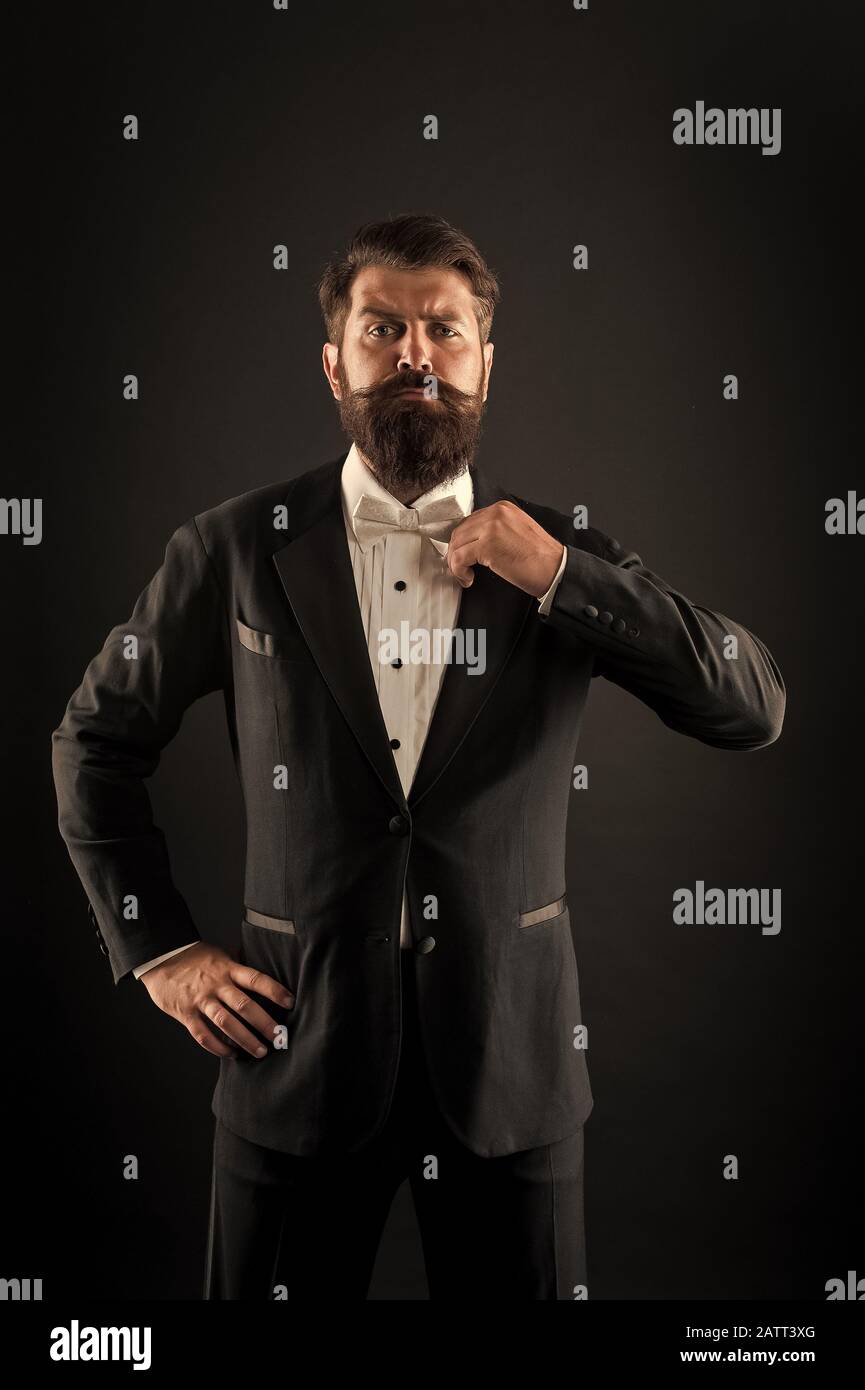 Hipster formal suit tuxedo. Difference between vintage and classic. Official event dress code. Classic style. Menswear classic outfit. Bearded man with bow tie. Well dressed and scrupulously neat. Stock Photo