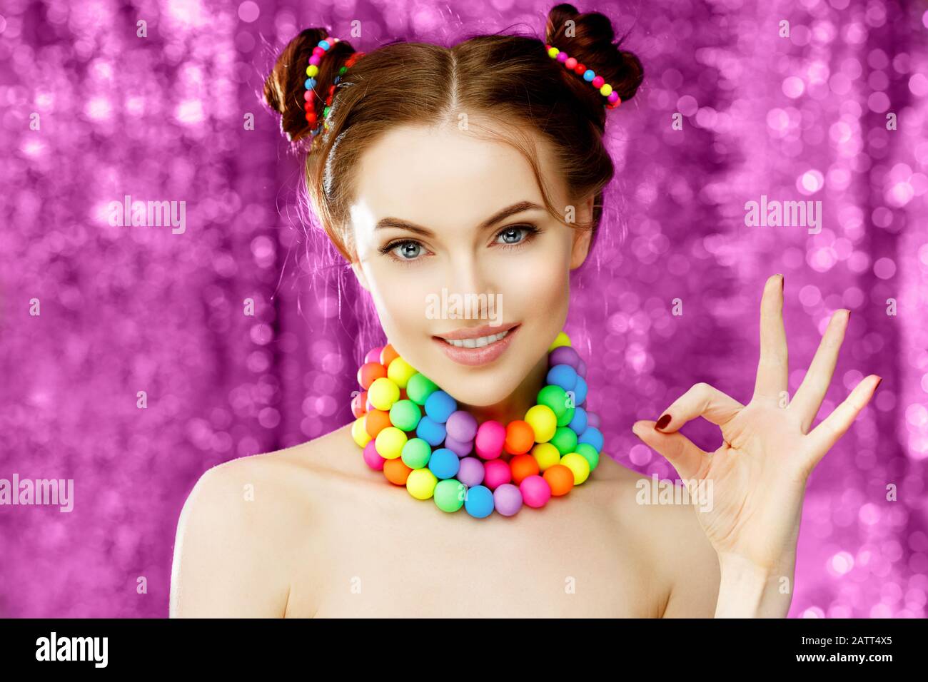 A Bright Girl Model Shows Okay Hand Fingers Beautiful Stylish Young Woman In A Candy Doll Style With Massive Beads Around Her Neck Stock Photo Alamy