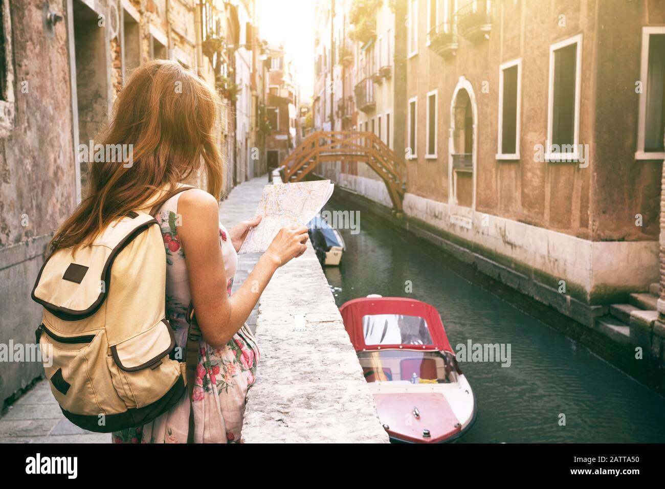 traveler girl looks at the map of walking in Venice, Italy Stock Photo