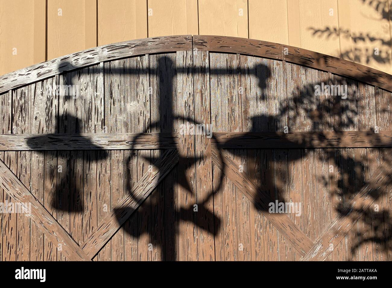 view of western ranch lanterns casting a shadow on barn doors Stock Photo