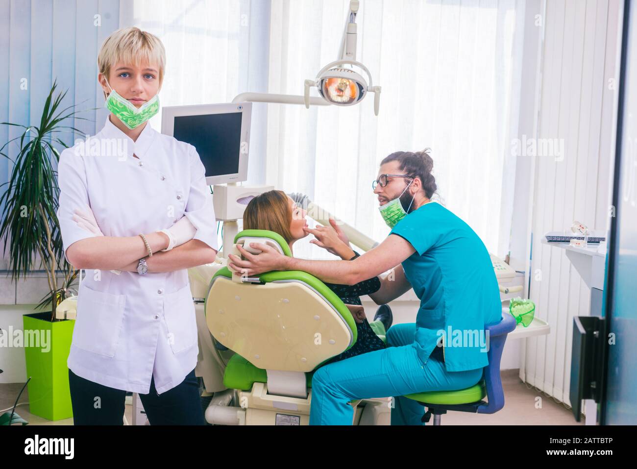 Young female dentist doctors standing with crossed hands in a white