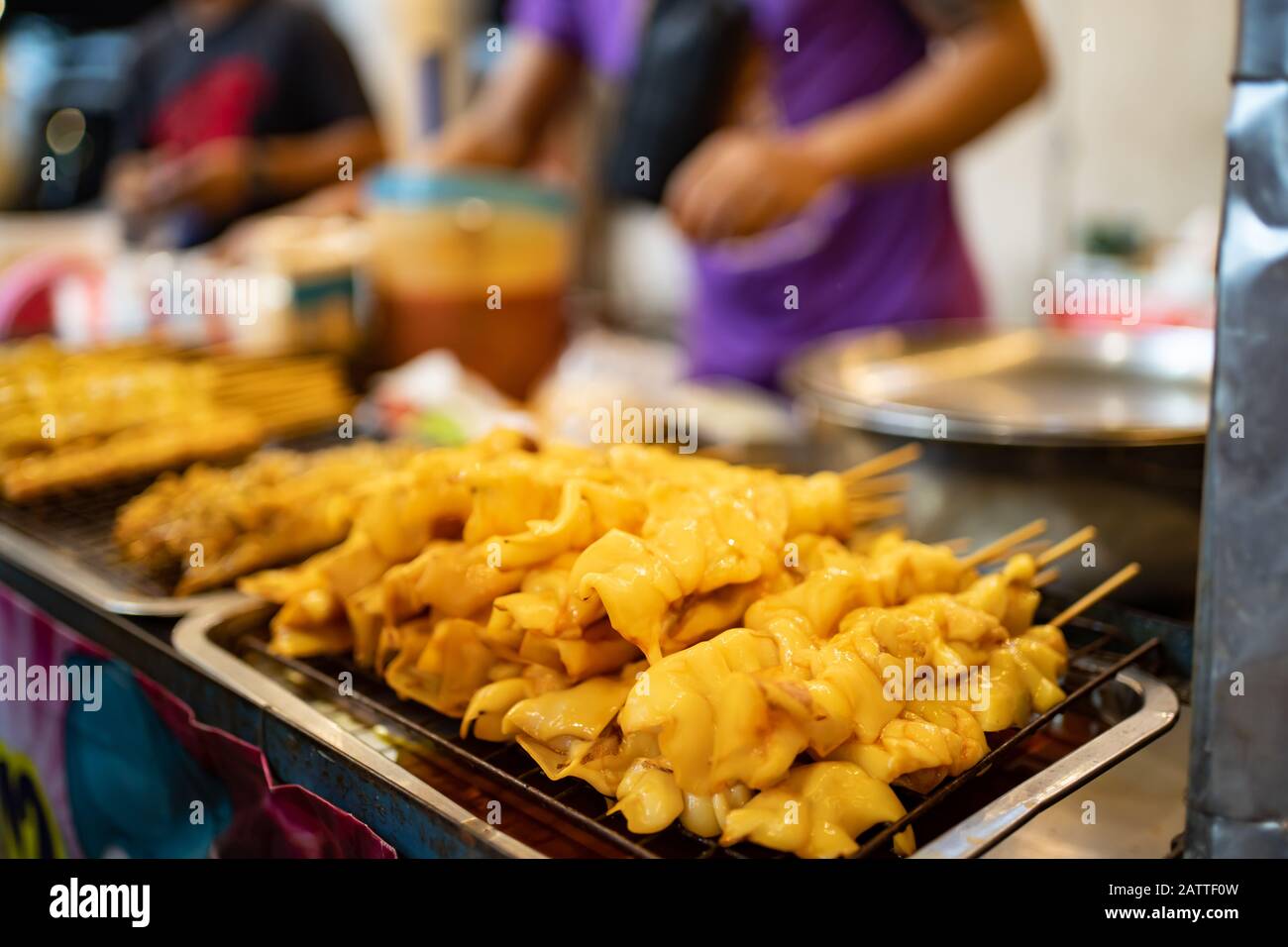 Squids on the grill in street food market in Bangkok, Thailand. Stock Photo