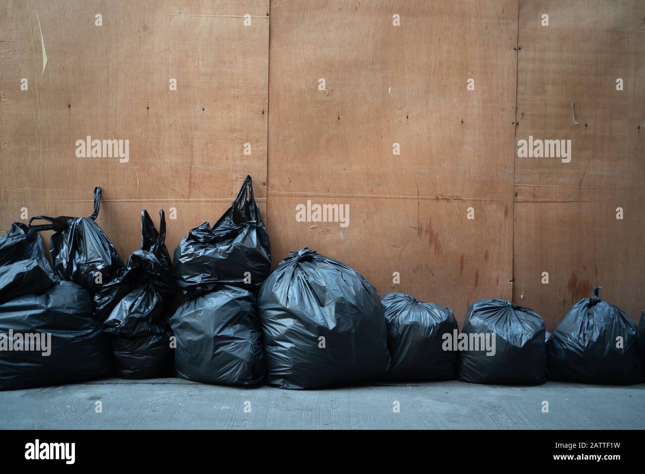 pile black garbage bag plastic and four dustbin dirty roadside in the city  with copy space add text Stock Photo - Alamy