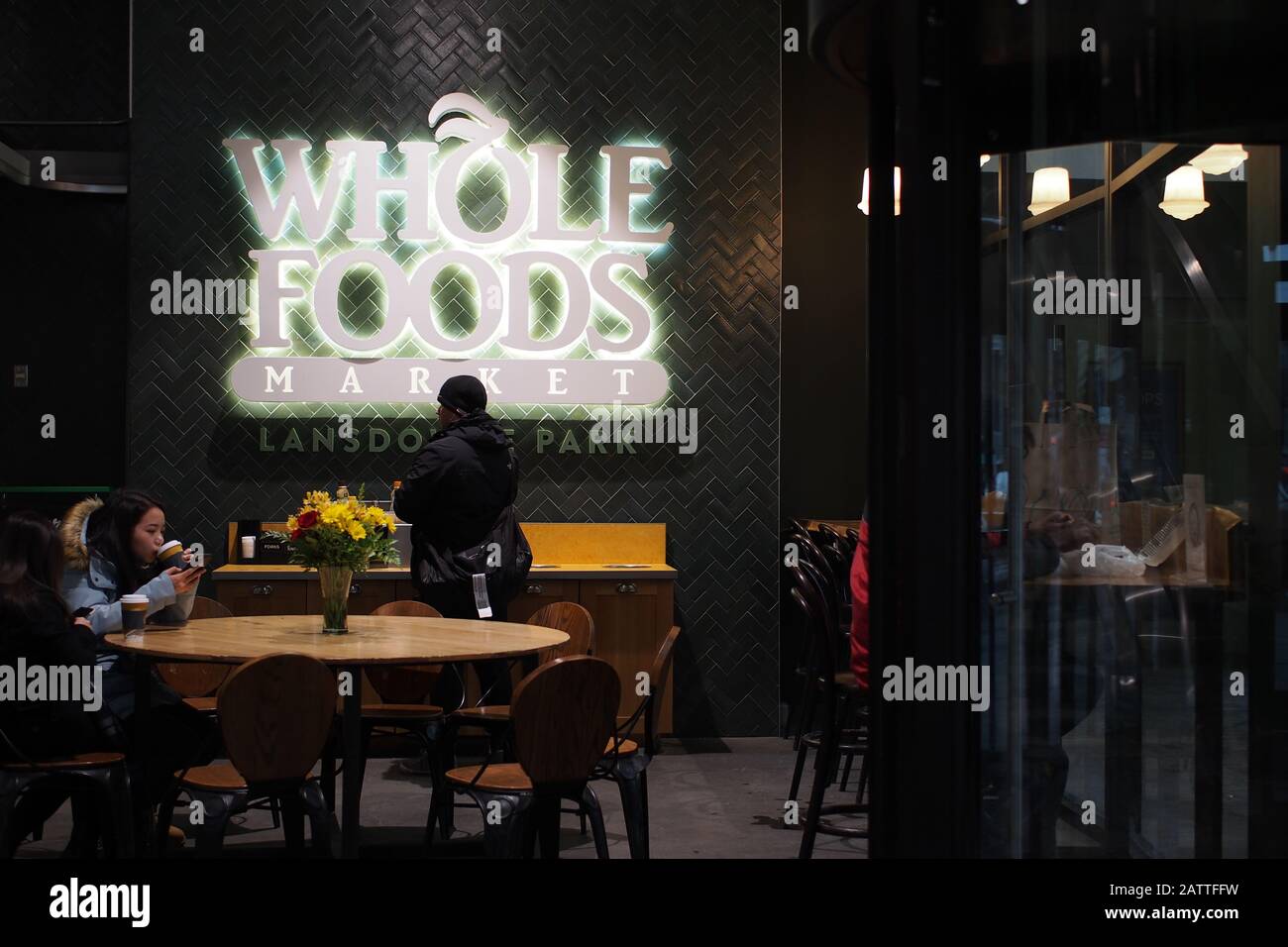 Shoppers having a coffee break at the Whole Foods Market front entrance