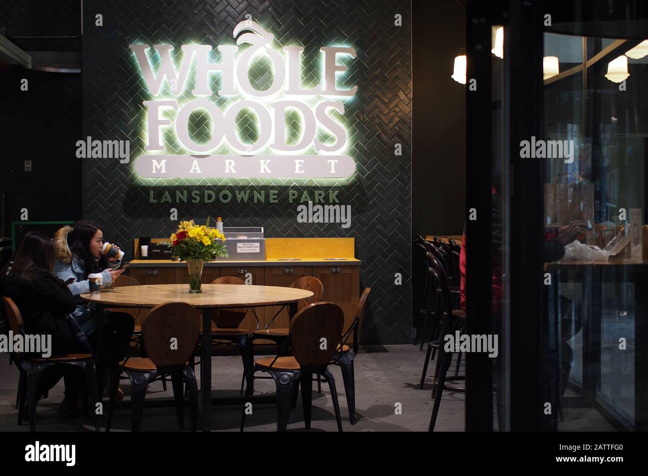Shoppers having a coffee break at the Whole Foods Market front entrance