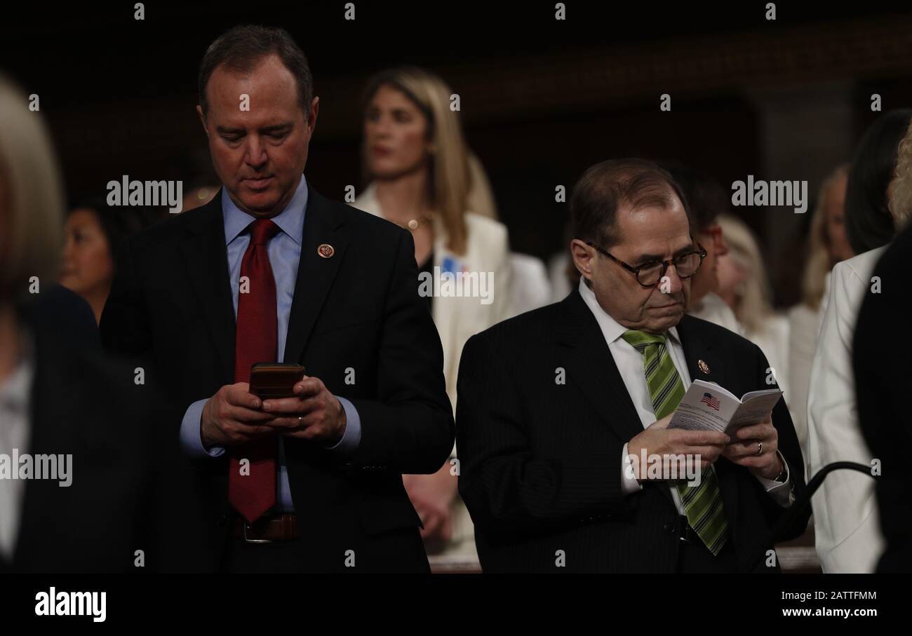 Washington DC, USA. 04th Feb, 2020. Lead House impeachment manager Rep Adam Schiff (D-CA) types on his phone as he and fellow manager and Judiciary Committee Chairman Jerry Nadler (D-NY) stands beside him reading a pocket copy of the U.S. Constitution as they wait for the start of U.S. President Donald Trump's State of the Union address to a joint session of the U.S. Congress in the House Chamber of the U.S. Capitol in Washington, U.S. February 4, 2020. Credit: Leah Millis/Pool via CNP /MediaPunch Credit: MediaPunch Inc/Alamy Live News Stock Photo