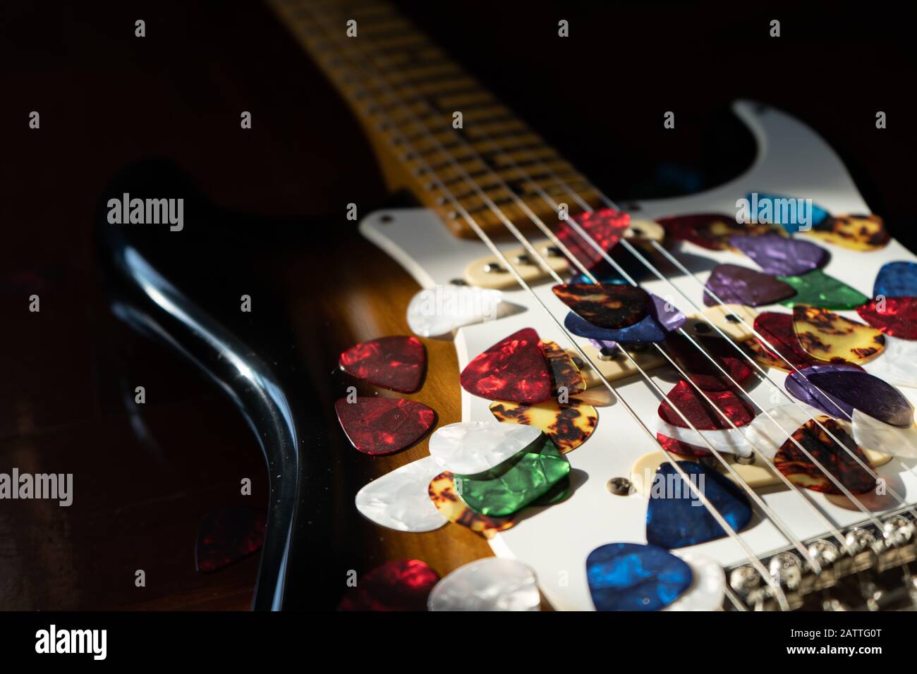 Guitar picks on electric guitar Stock Photo