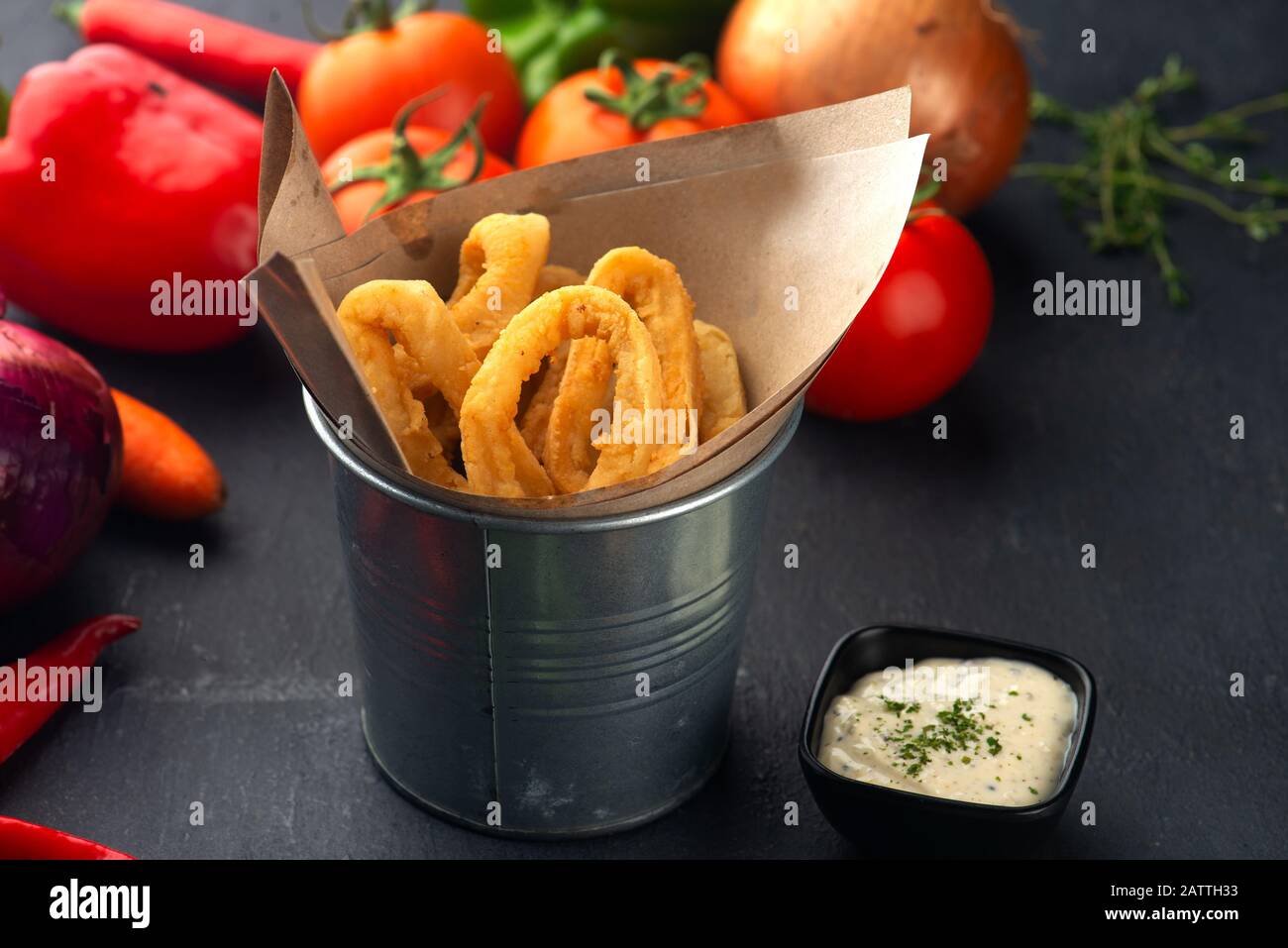 crispy calamari rings on basket with tartar sauce Stock Photo
