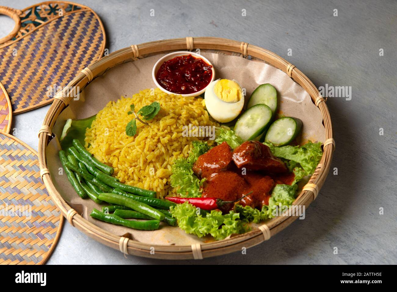 Turmeric rice with curry or nasi kunyit kuning, popular dish in malaysia Stock Photo