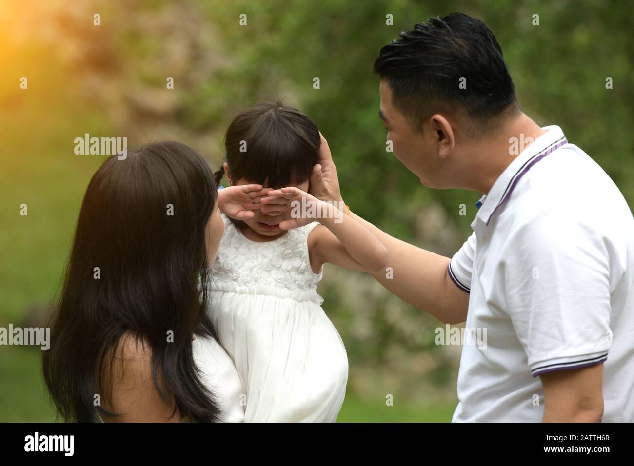asian girl crying with family comforting Stock Photo