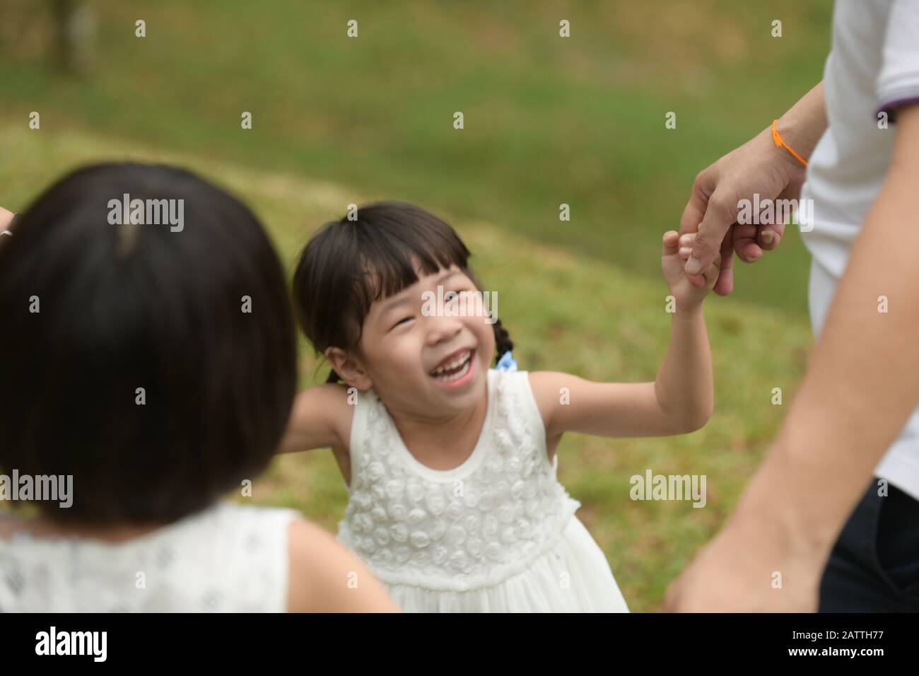 happy asian girl playing with family Stock Photo
