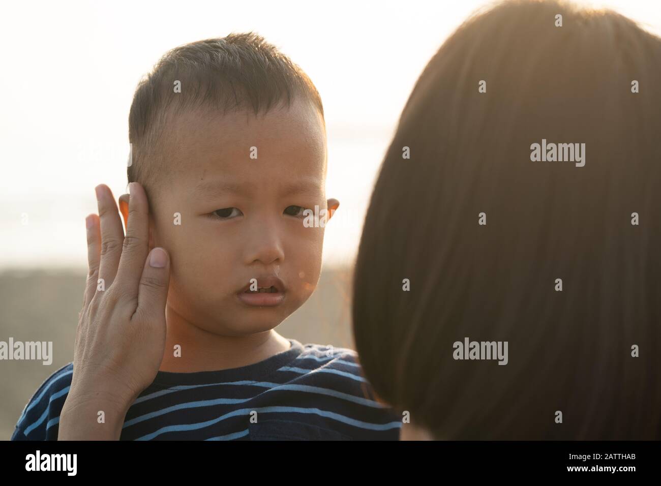 asian boy crying with mother comforting Stock Photo