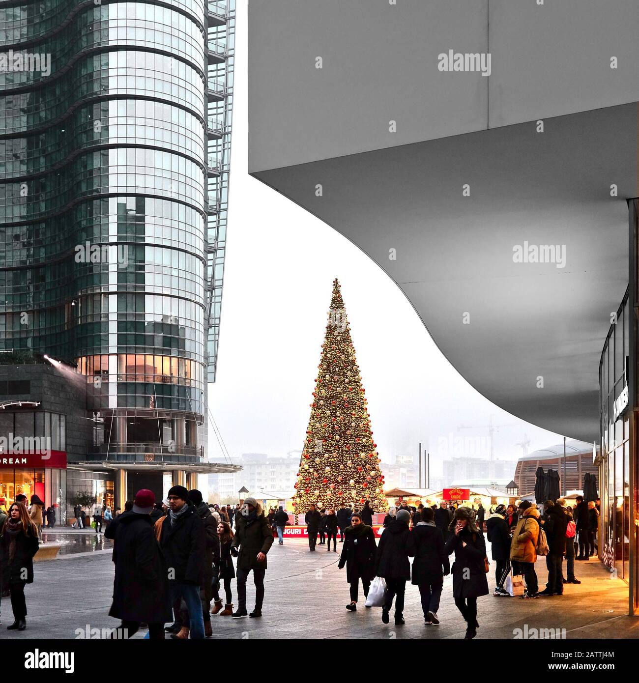 Christmas tree and christmas market in Gae Aulenti square with Unicredit tower and people - Milan, Italy Stock Photo