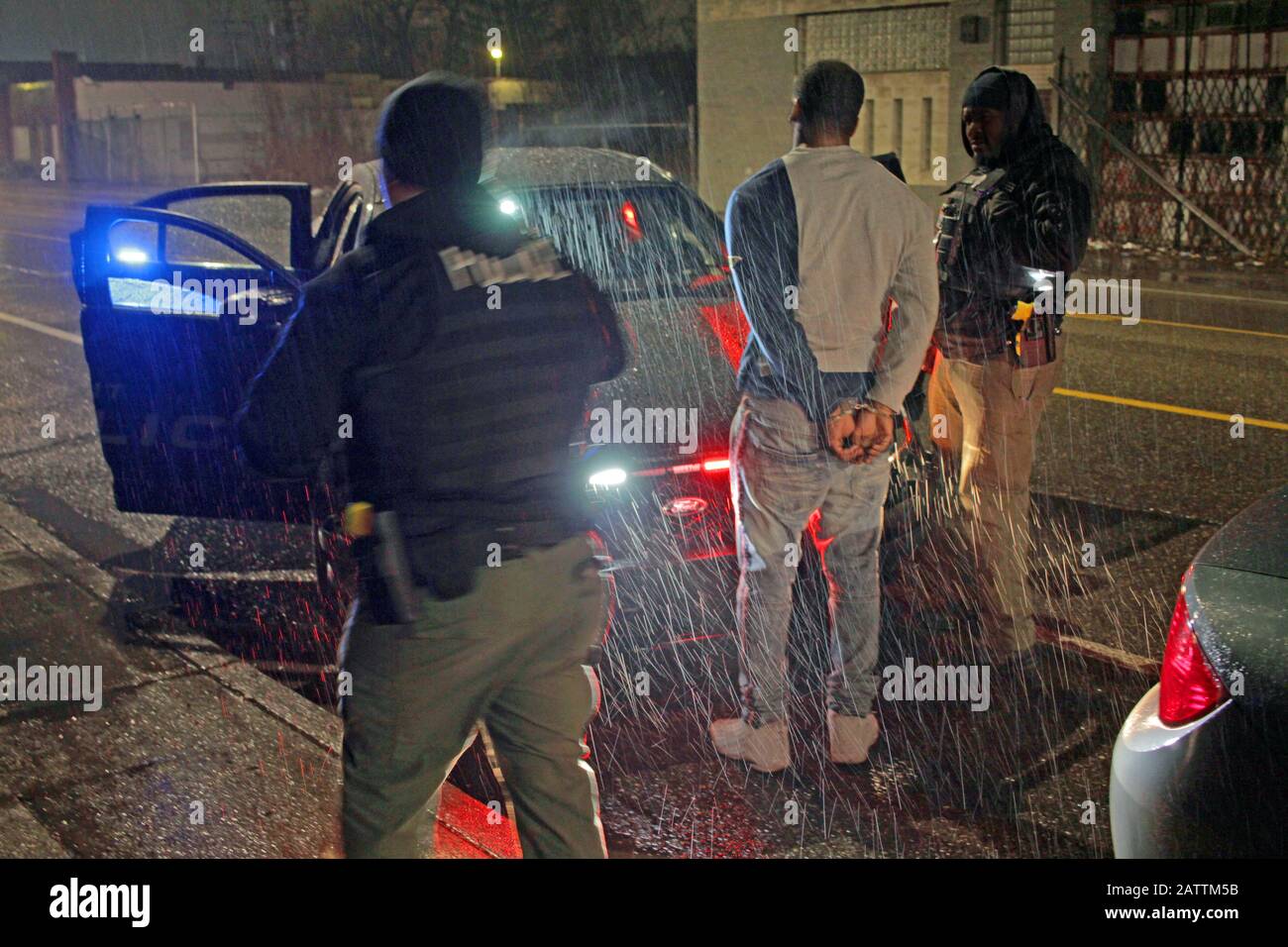 Detroit police Special stop a vehicle on a rainy night and detain the driver to carry out checks, Detroit, Michigan, USA Stock Photo
