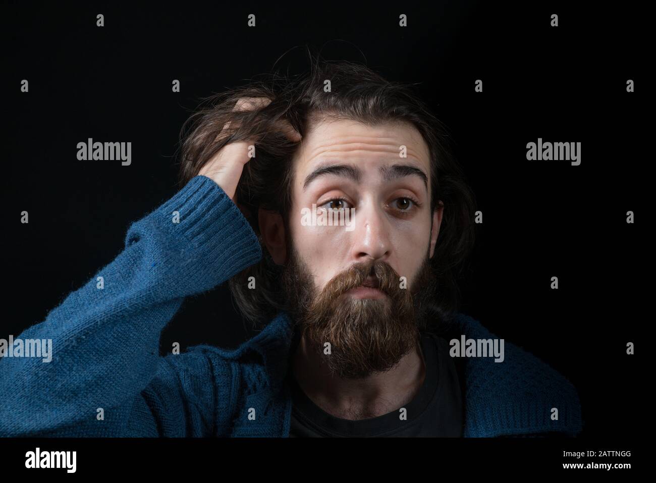 Hipster man solves a problem and thinks. Shot on black isolated background. Thinks Concept. Stock Photo
