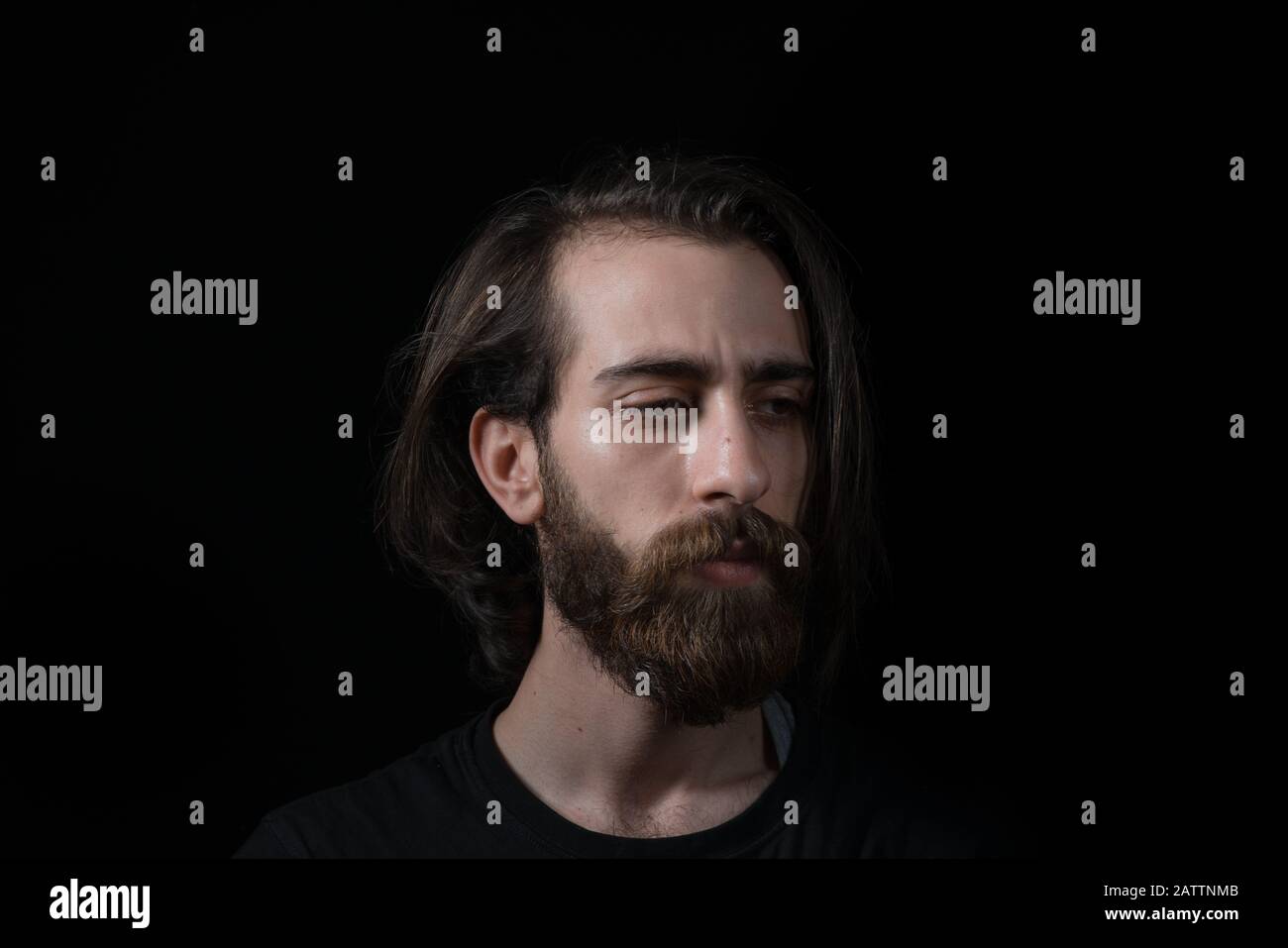Hipster man solves a problem and thinks. Shot on black isolated background. Thinks Concept. Stock Photo