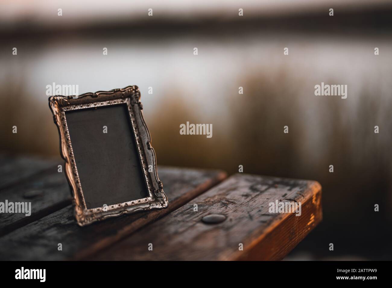 Empty photo frame on the table outside. Background Concept. Stock Photo