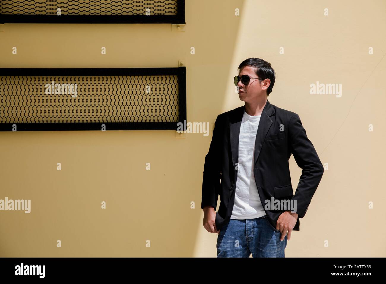 A man with glasses and a black suit Stock Photo